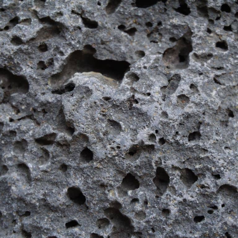 Color/Finish variation image for Ankar Lava Basalt. The surface finishes shown are split-face and tumbled. Dominant colors shown are black and gray; with blue and brown secondaries. The color mix creates a cool feeling. Regular color pattern.