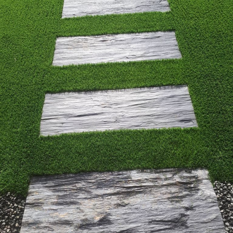 The image shows this material being used in a path pavers application.