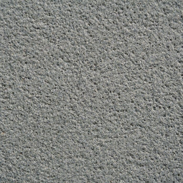 Color/Finish variation image for Ankar Gray Basalt. The surface finish shown is sand blasted. The dominant color shown is gray; with a green secondary. The color mix creates a cool feeling. Fine speckled color pattern.