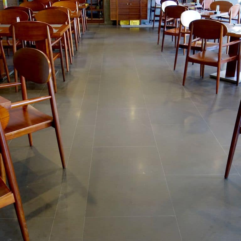 The image shows this material being used in an interior floor application.