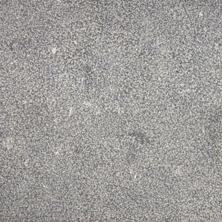 Color/Finish variation image for Belgian Bluestone. The surface finish shown is bush hammered. The dominant color shown is gray; with beige, pink, purple and white secondaries. The color mix creates a cool feeling. Speckled and cloudy color patterns.