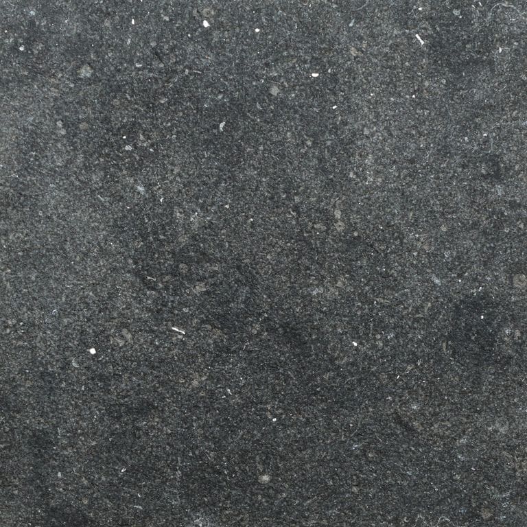 Color/Finish variation image for Belgian Bluestone Limestone. The surface finish shown is sand blasted. Dominant colors shown are black and gray. The color mix creates a cool feeling.