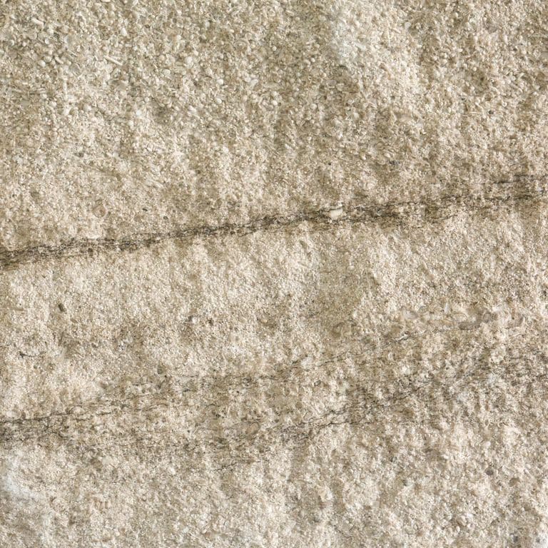Color/Finish variation image for Silver Shadow Limestone. The surface finish shown is split-face. Dominant colors shown are beige and tan; with brown, gray, orange/rust and cream secondaries. Exhibits "movement" and the color mix creates a warm feeling. Fine speckled, blotched and veined color patterns.