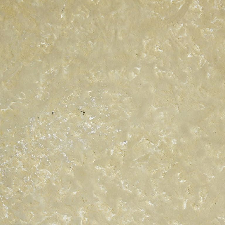 Color/Finish variation image for Northern Buff Limestone. The surface finishes shown are antiqued and brushed. Dominant colors shown are beige and tan; with brown, orange/rust and cream secondaries. Exhibits "movement" and the color mix creates a warm feeling. Blotched, swirled and cloudy color patterns.