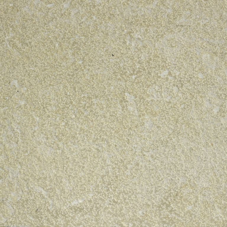 Color/Finish variation image for Northern Buff Limestone. The surface finish shown is bush hammered. Dominant colors shown are beige and tan; with brown, gray, orange/rust and cream secondaries. The color mix creates a warm feeling. Fine speckled and cloudy color patterns.