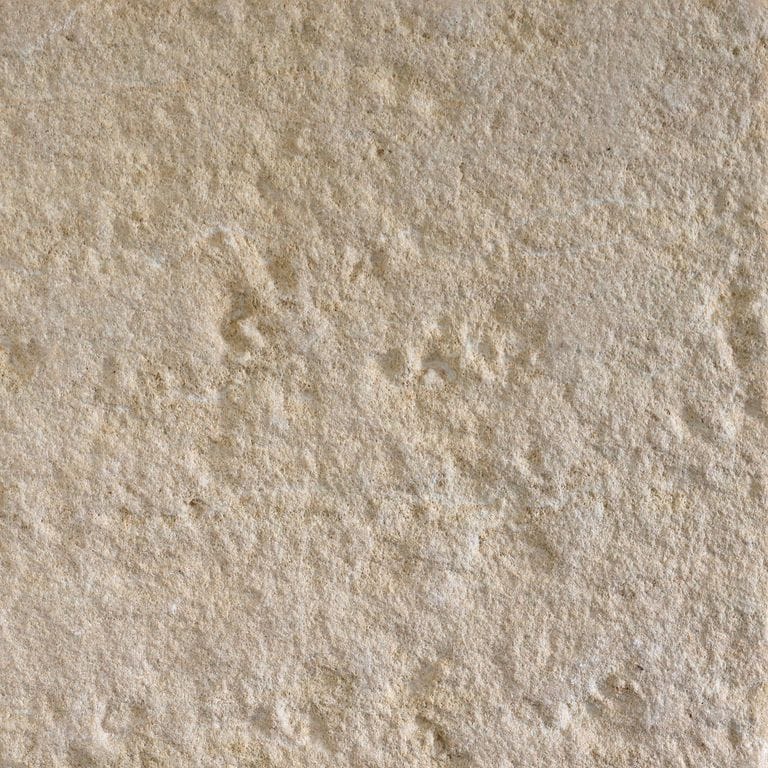 Color/Finish variation image for Northern Buff Limestone. The surface finish shown is sand blasted. The dominant color shown is tan; with beige, brown, gray and orange/rust secondaries. The color mix creates a warm feeling. Fine speckled, blotched and cloudy color patterns.