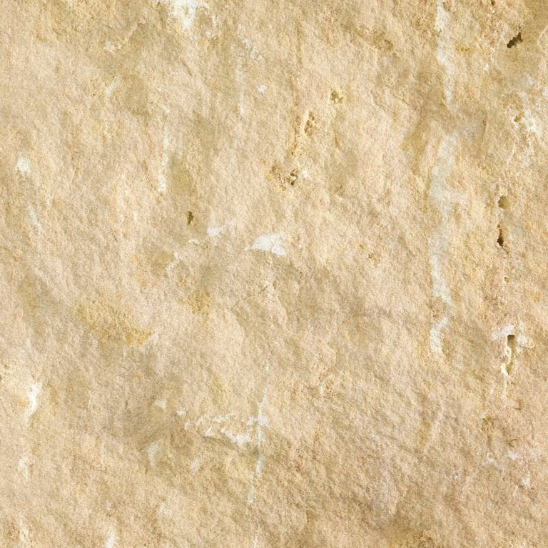 Color/Finish variation image for Champagne Plains Limestone. The surface finish shown is split-face. Dominant colors shown are beige and tan; with brown, orange/rust and cream secondaries. Exhibits "movement" and the color mix creates a warm feeling. Blotched, swirled and cloudy color patterns.