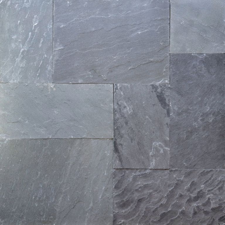 Best close-up image for Bluestone Natural Cleft - Blue/Gray. The image shows this material being used for full bed veneer and thin veneer. The surface finish shown is natural cleft. Dominant colors shown are blue and gray; with a green secondary. Exhibits "movement" and the color mix creates a cool feeling. Regular color pattern.