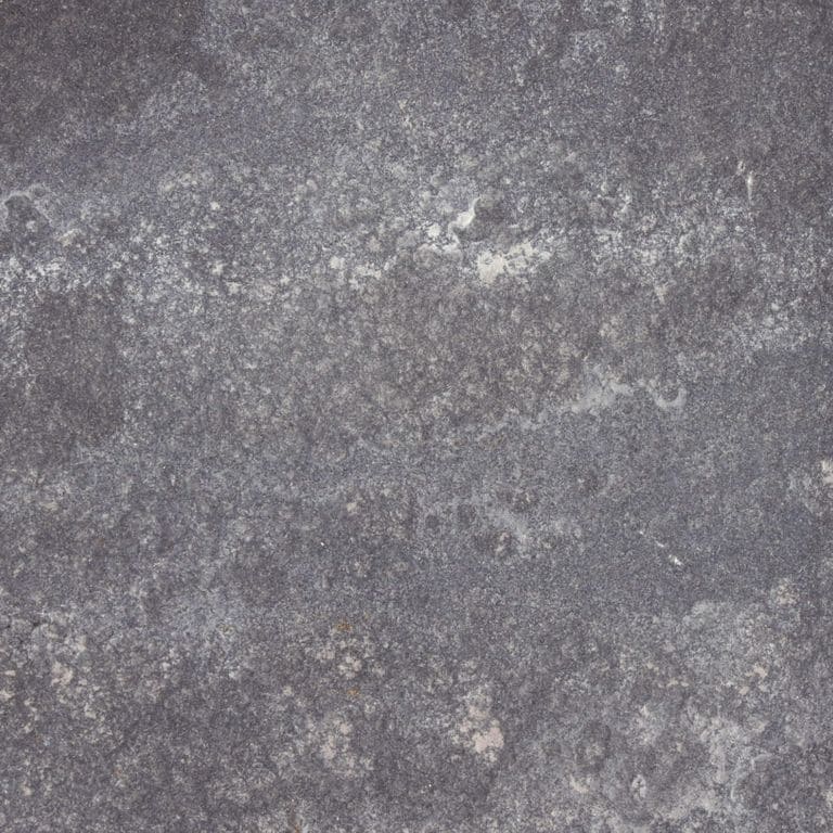 Swatch image cropped for Bluestone Flamed Surface - Lilac. The surface finishes shown are brushed and flamed. Dominant colors shown are gray and purple; with a green secondary. Exhibits "movement" and the color mix creates a cool feeling. Random and blotched color patterns.