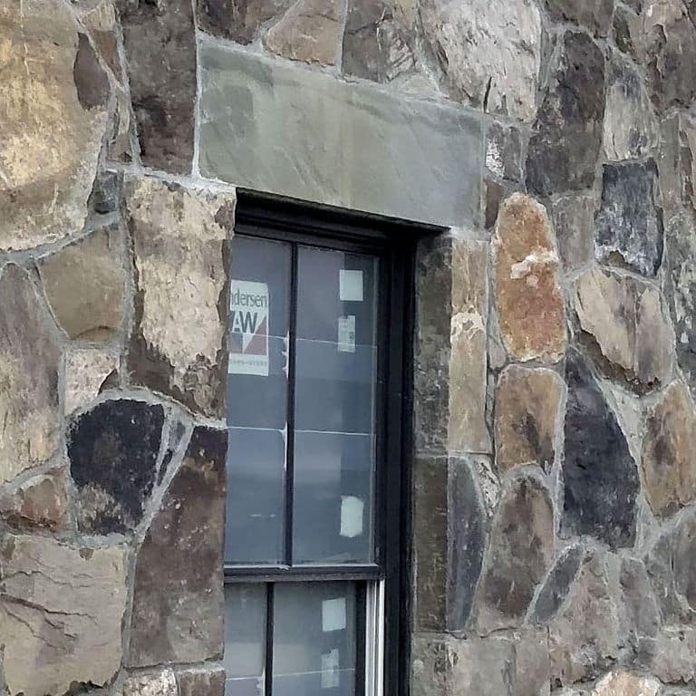 Application image for Bluestone Natural Cleft - Green/Brown. The image shows this material being used in an architectural elements application. This is a building and landscape stone for indoor and outdoor commercial and residential applications. Suitable for general use, freeze-thaw conditions, low slipperiness surfaces and high heel compatibilty situations. Moderate to higher on the price spectrum.