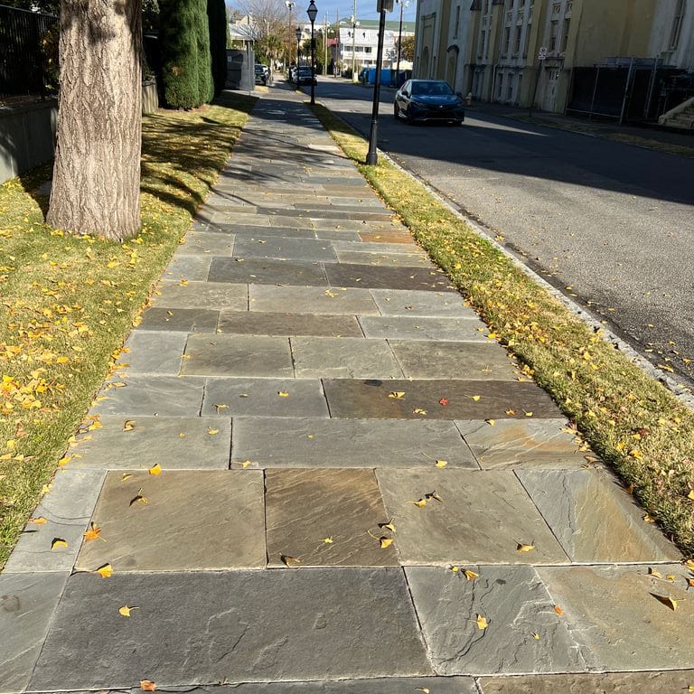 Application image for Full Color Mix Bluestone - Natural Cleft. The image shows this material being used in a path pavers application. The surface finish shown is natural cleft. Dominant colors shown are beige, brown, orange/rust and tan. The color mix creates a warm feeling.