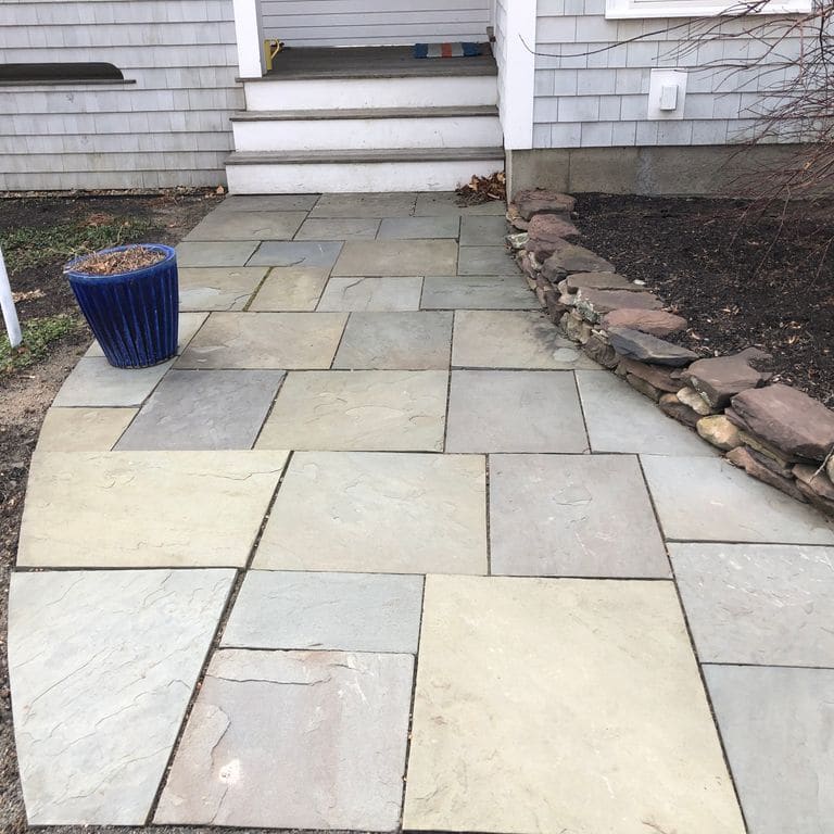The image shows this material being used in a path pavers application.