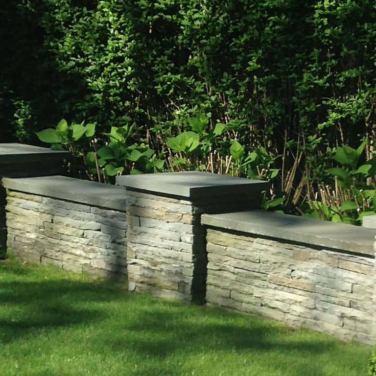 The image shows this material being used in a landscape wallstone application.