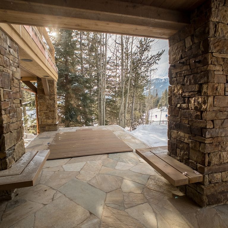Feature image for Slate - Mandarin Yellow. The image shows this material being used in a patio pavers application. The surface finish shown is natural cleft. Dominant colors shown are brown, gray, orange/rust and tan; with a purple secondary. The color mix creates a warm feeling. Random color pattern.
