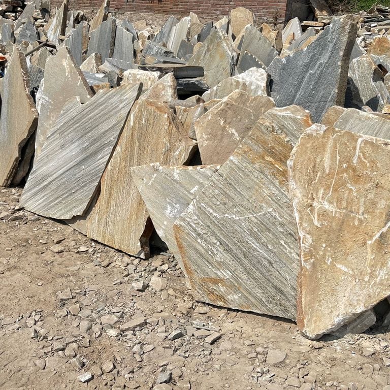Application image for Slate - Mandarin Yellow. The surface finish shown is natural cleft. Dominant colors shown are beige and tan; with brown, gray, orange/rust, white and cream secondaries. The color mix creates a warm feeling. Streaked and random color patterns.