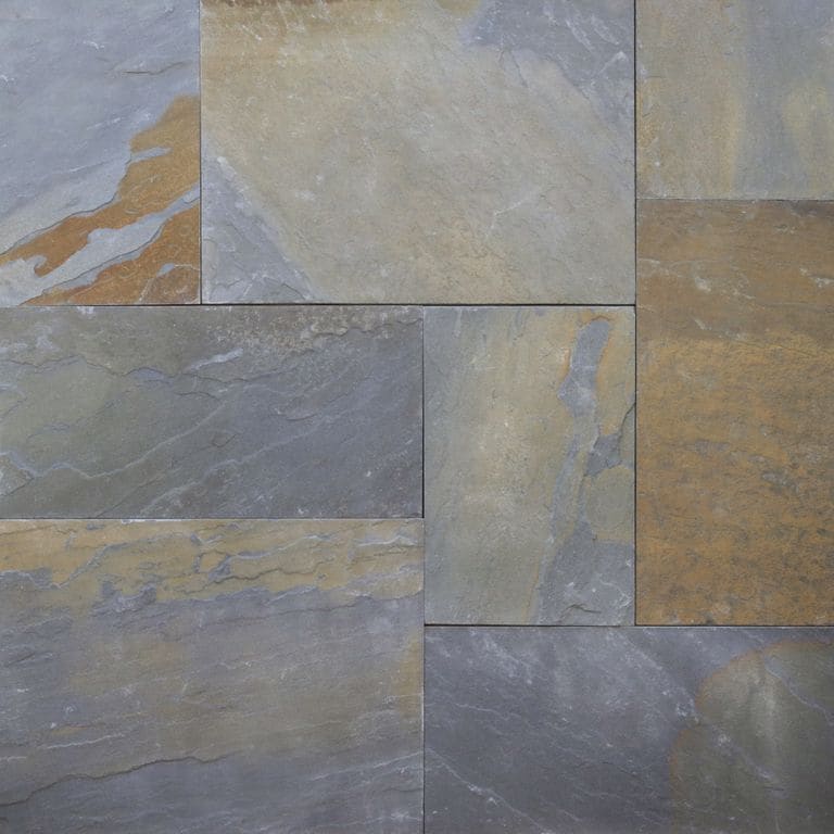 Close-up image for Bluestone Natural Cleft - Rust Tones. The surface finish shown is natural cleft. Dominant colors shown are blue, gray and orange/rust; with brown, green, purple and tan secondaries. Exhibits "movement" and the color mix creates a warm feeling. Random, blotched and streaked color patterns.