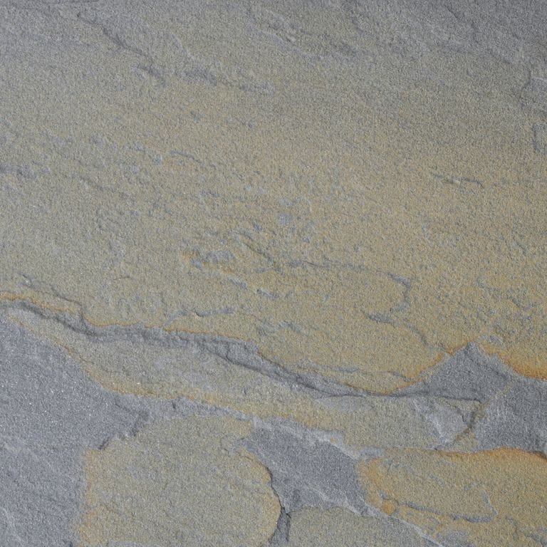 Feature image for Bluestone - Rust Tones - Natural Cleft. The surface finish shown is natural cleft. Dominant colors shown are green, gray and tan; with blue, brown, orange/rust, purple and tan secondaries. Exhibits "movement" and the color mix creates a warm feeling. Random color pattern.