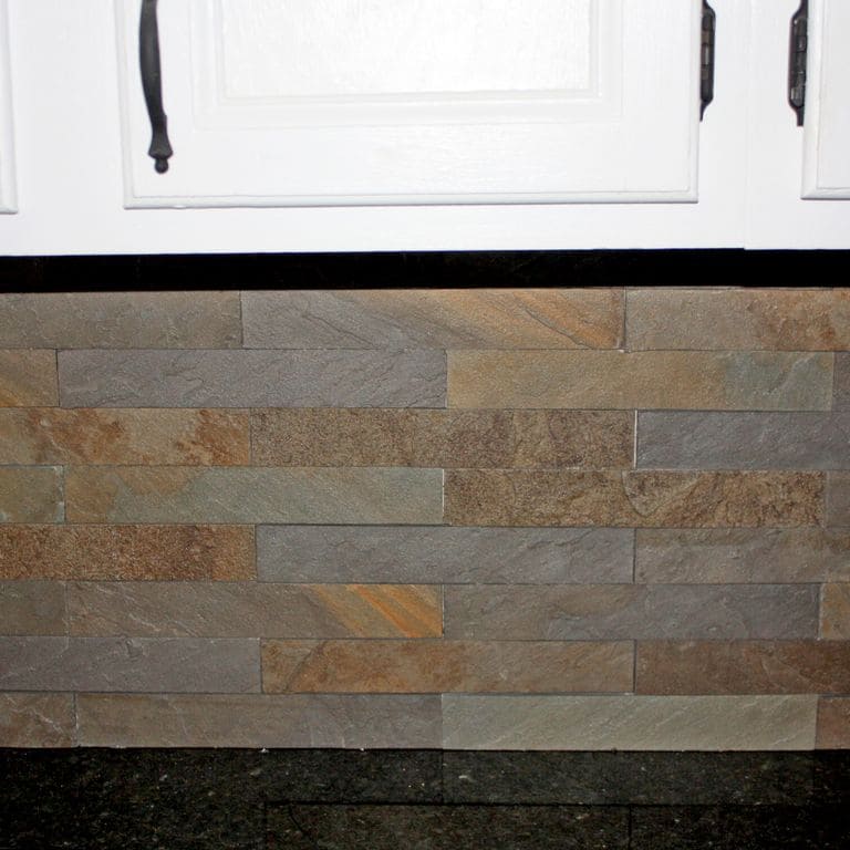 Feature image for Bluestone Natural Cleft - Burgundy/Brown Mix. The image shows this material being used in a thin veneer application. Dominant colors shown are brown and gray; with green, orange/rust, purple, white, tan and cream secondaries. The color mix creates a warm feeling. Random, blotched, streaked and cloudy color patterns.