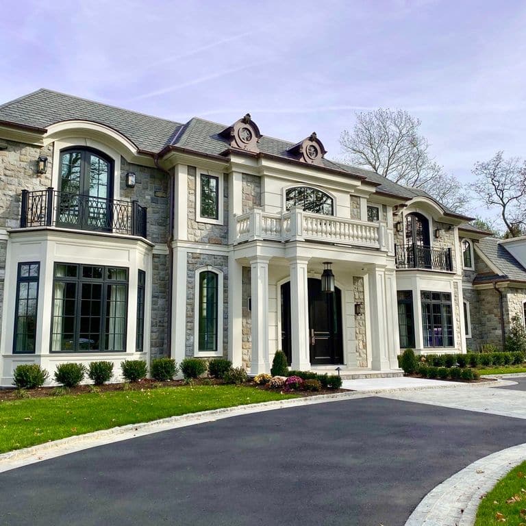 Feature image for Adirondack Elite Granite. The image shows this material being used for landscape curbing &amp; edging, full bed veneer and thin veneer. The surface finish shown is split-face. Dominant colors shown are gray and white; with beige, pink, tan and cream secondaries. The color mix creates a warm feeling. Regular and fine speckled color patterns.
