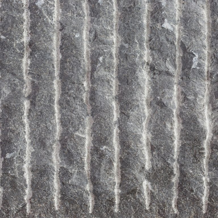 Color/Finish variation image for Highland Limestone. The surface finish shown is point stalk. The dominant color shown is gray; with brown, green, purple and white secondaries. Exhibits "movement" and the color mix creates a cool feeling. Blotched, linear and swirled color patterns.