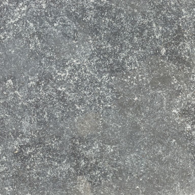 Close-up image for Highland Limestone. The surface finish shown is tumbled. The dominant color shown is gray; with brown, green, purple, white and tan secondaries. Exhibits "movement" and the color mix creates a cool feeling. Regular, speckled and blotched color patterns.