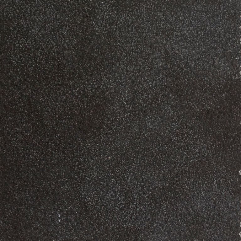 Feature image for Absolute Black Granite. The surface finish shown is polished. The dominant color shown is black; with brown, gray and purple secondaries. The color mix creates a cool feeling. Solid and fine speckled color patterns.