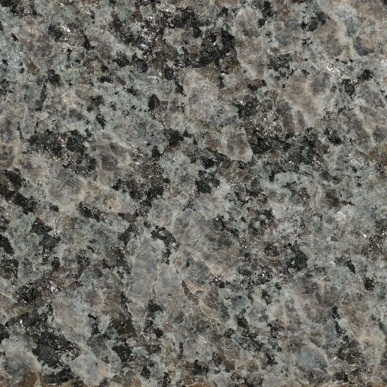 Color/Finish variation image for Caledonia Granite. The surface finish shown is flamed. Dominant colors shown are brown and gray. The color mix creates a cool feeling.