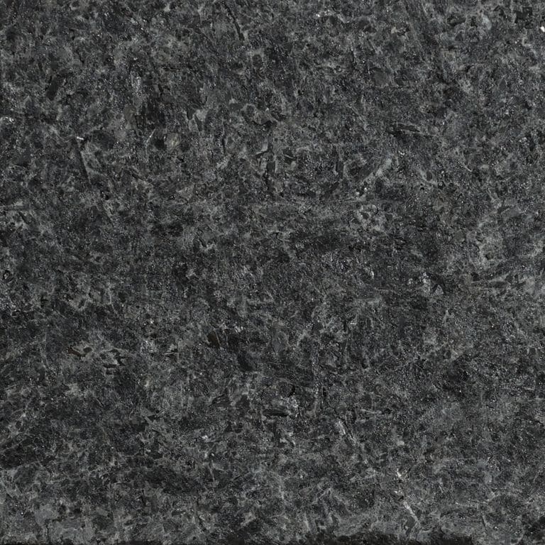 Feature image for Cambrian Black Granite. The surface finish shown is flamed. Dominant colors shown are black and gray; with black and purple secondaries. The color mix creates a cool feeling.