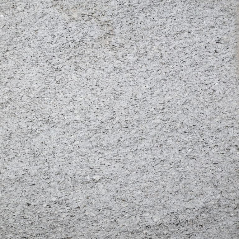 Color/Finish variation image for Chelmsford Gray Granite. The surface finish shown is flamed. Dominant colors shown are gray and white. The color mix creates a cool feeling.