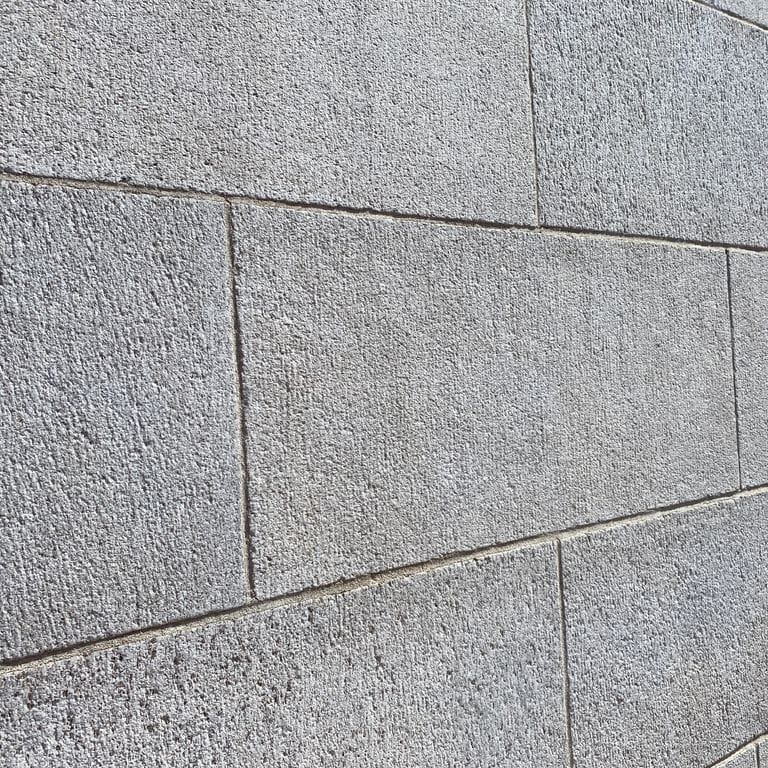 Application image for Chelmsford Gray Granite. The image shows this material being used in a full bed veneer application. The surface finish shown is sand blasted. Dominant colors shown are gray and white. The color mix creates a cool feeling. Speckled color pattern.