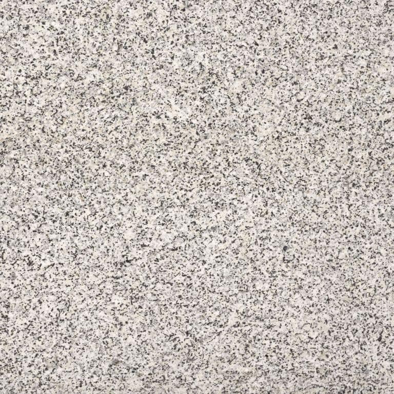 Feature image for Coastal Gray Granite. Dominant colors shown are beige, gray, white and cream; with a pink secondary. The color mix creates a warm feeling. Speckled color pattern.