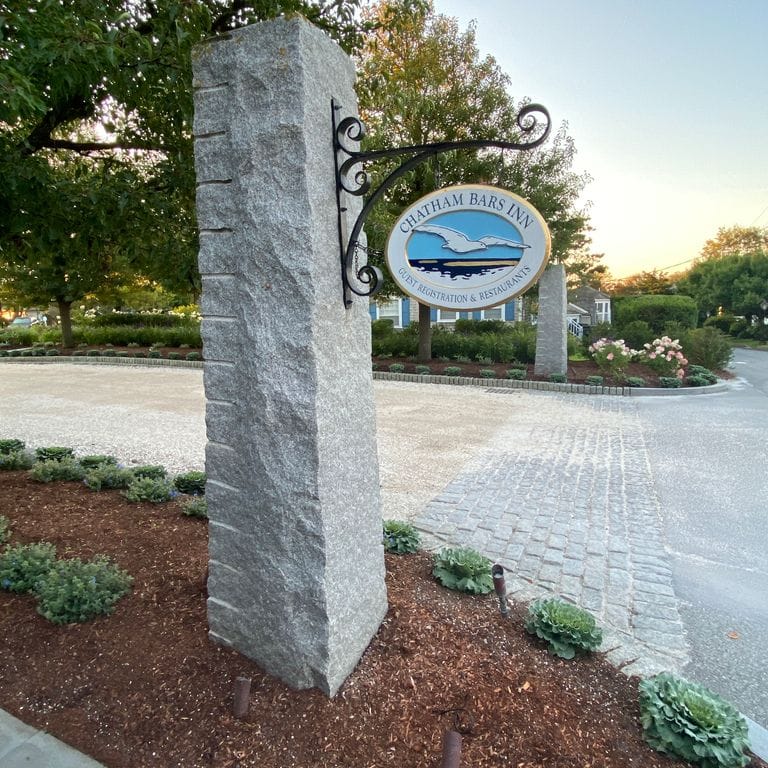 Application image for Dodlin Hill Granite. The image shows this material being used in a posts application. This is a building and landscape stone for indoor and outdoor commercial and residential applications. Suitable for general use, freeze-thaw conditions, low heat absorption surfaces, high traffic areas, low slipperiness surfaces and high heel compatibilty situations. Relatively moderate in price.