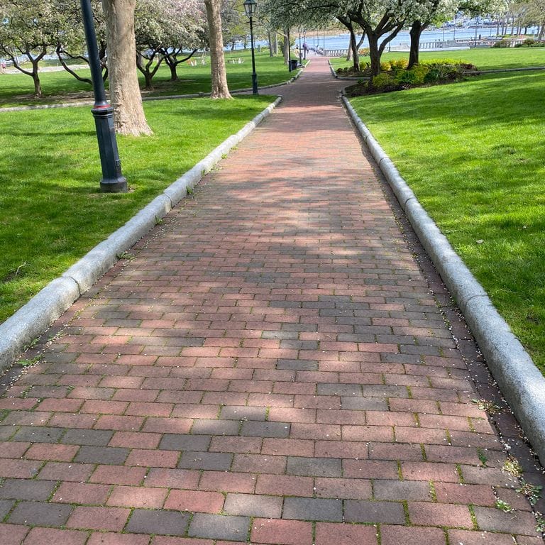 Application image for Kitledge Grey Granite. The image shows this material being used in a landscape curbing &amp; edging application. This is a building and landscape stone for indoor and outdoor commercial and residential applications. Suitable for general use, freeze-thaw conditions, low heat absorption surfaces, high traffic areas, low slipperiness surfaces and high heel compatibilty situations. Moderate to higher on the price spectrum.