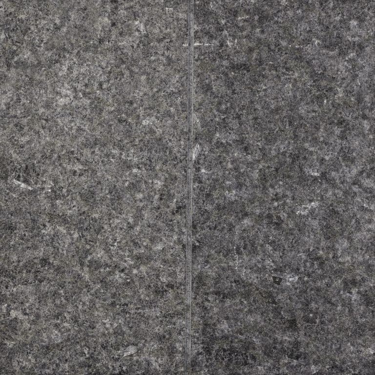Feature image for Peribonka Granite. The surface finish shown is flamed. The dominant color shown is gray; with black, brown and purple secondaries. The color mix creates a cool feeling. Speckled color pattern. Contains some mica and mineral inclusions.
