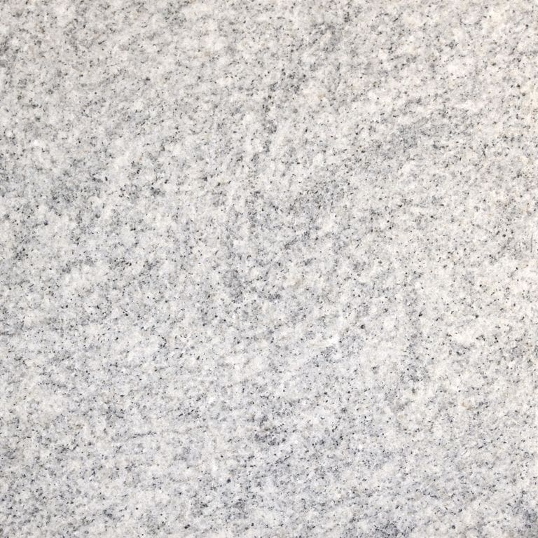 Color/Finish variation image for Silver Cloud Granite. The surface finish shown is flamed. Dominant colors shown are gray and white; with beige, pink and cream secondaries. The color mix creates a cool feeling. Speckled and cloudy color patterns.