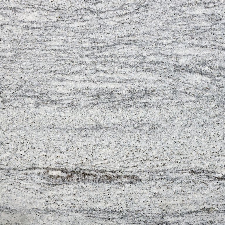 Color/Finish variation image for Silver Cloud Granite. The surface finish shown is flamed. Dominant colors shown are gray and white. The color mix creates a cool feeling. Streaked, fine speckled and random color patterns.