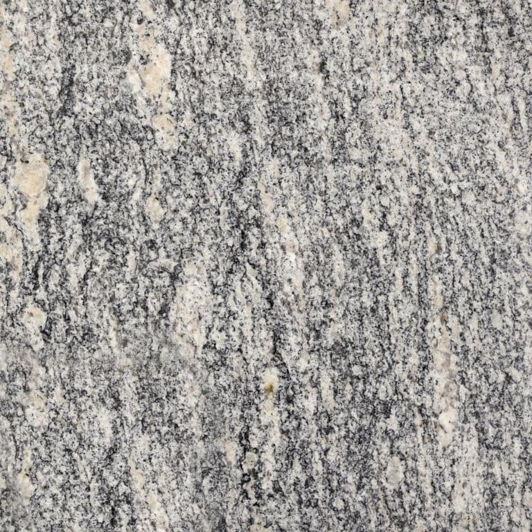 Swatch image for Granite - Tapestry. The surface finish shown is polished. The dominant color shown is gray; with beige, pink, white and cream secondaries. Exhibits "movement" and the color mix creates a warm feeling. Streaked and random color patterns. Contains some mica and mineral inclusions.