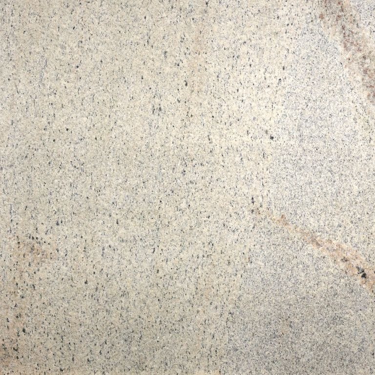 Feature image for Phoenician Buff Granite. The dominant color shown is beige; with gray, white, tan and cream secondaries. Exhibits "movement" and the color mix creates a warm feeling. Random, speckled, fine speckled and veined color patterns. Contains lots of mica and mineral inclusions.