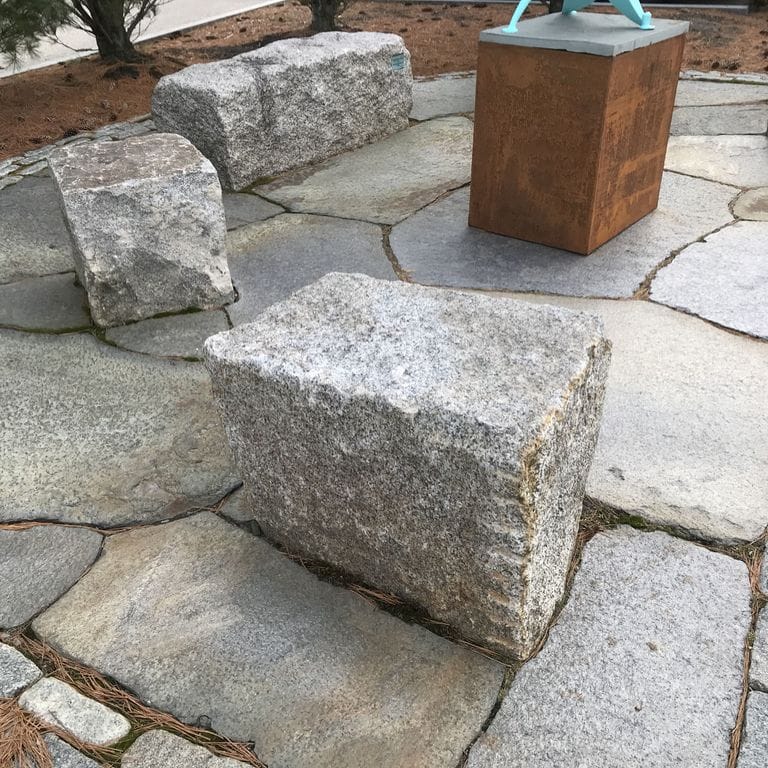 The image shows this material being used in a patio pavers application. Speckled and fine speckled color patterns.