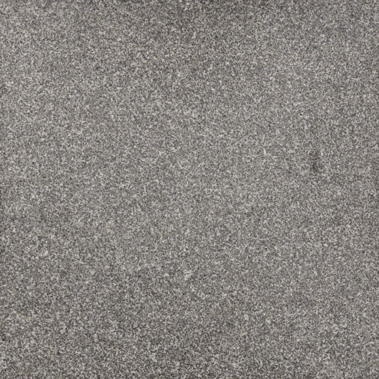 Color/Finish variation image for Jet Mist Granite. The surface finish shown is flamed. The dominant color shown is gray; with brown, green and purple secondaries. Fine speckled color pattern.