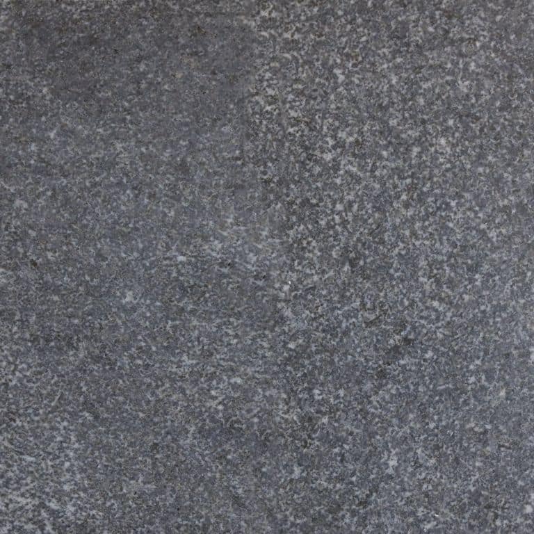 Color/Finish variation image for Jet Mist Granite. The surface finish shown is honed. The dominant color shown is gray; with blue, brown, green and purple secondaries. The color mix creates a cool feeling. Speckled, blotched and cloudy color patterns.