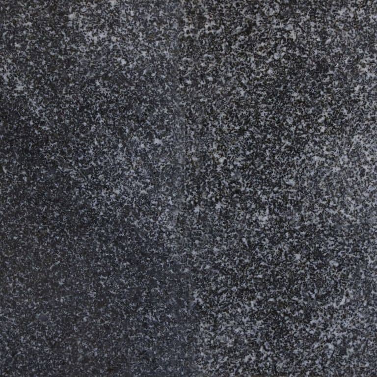 Color/Finish variation image for Jet Mist Granite. The surface finish shown is polished. Dominant colors shown are black and gray; with blue and brown secondaries. Exhibits "movement" and the color mix creates a cool feeling. Speckled and blotched color patterns.