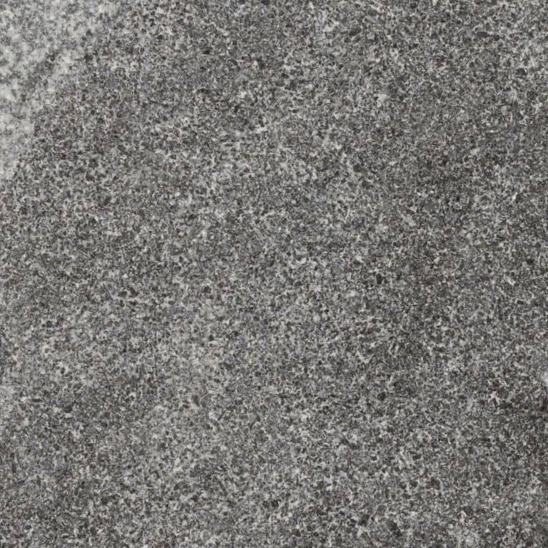 Color/Finish variation image for Jet Mist Granite. The surface finish shown is split-face. The dominant color shown is gray; with brown, green and purple secondaries. The color mix creates a cool feeling. Speckled and cloudy color patterns.