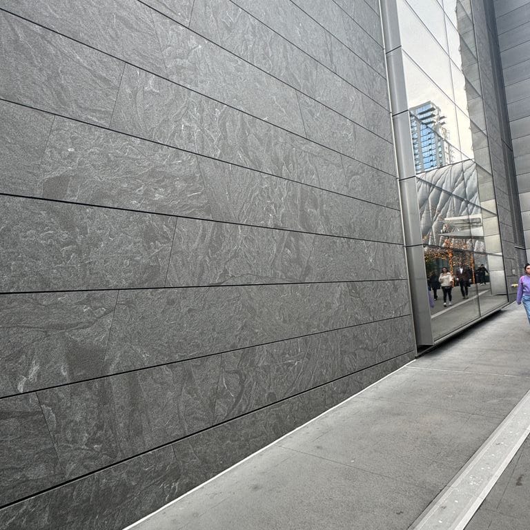 Application image for Granite - Jet Mist. The image shows this material being used for full bed veneer and thin veneer. The dominant color shown is gray. The color mix creates a cool feeling.
