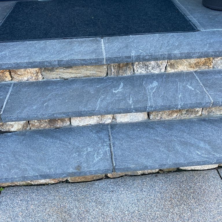Application image for Granite - Jet Mist. The image shows this material being used in a treads application. The dominant color shown is gray. The color mix creates a cool feeling.