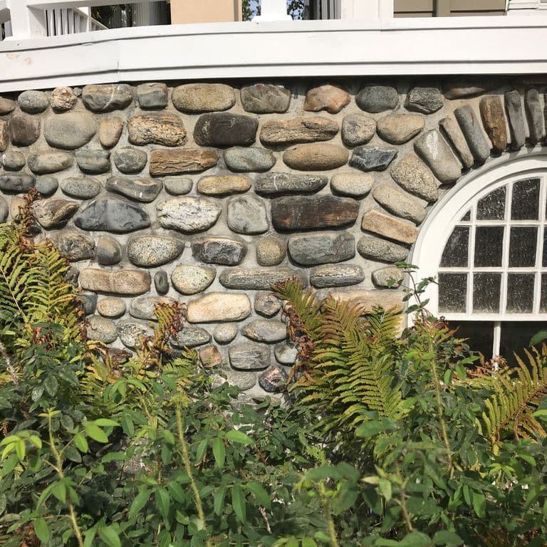 Application image for Beach Rounds. The image shows this material being used in a full bed veneer application. The surface finish shown is . Dominant colors shown are beige, brown, gray and tan. The color mix creates a warm feeling. Regular color pattern.