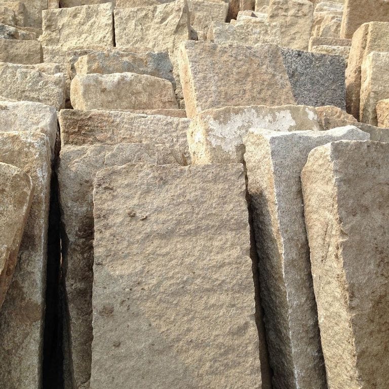 Best close-up image for Reclaimed Rustic Granite. The surface finish shown is . Dominant colors shown are beige, brown and tan; with gray, orange/rust, white and cream secondaries. The color mix creates a warm feeling. Regular, speckled and blotched color patterns.