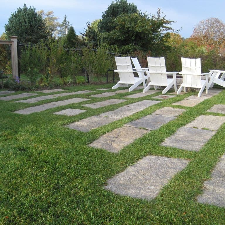 The image shows this material being used in a patio pavers application.