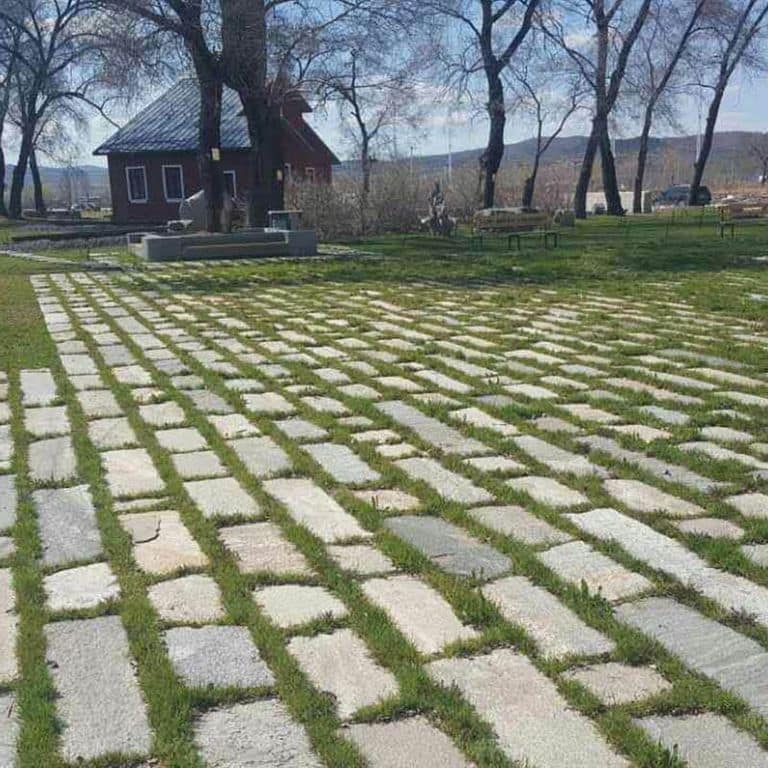 Application image for Reclaimed Rustic Granite. The image shows this material being used in a patio pavers application. The surface finish shown is . The dominant color shown is gray. The color mix creates a cool feeling.