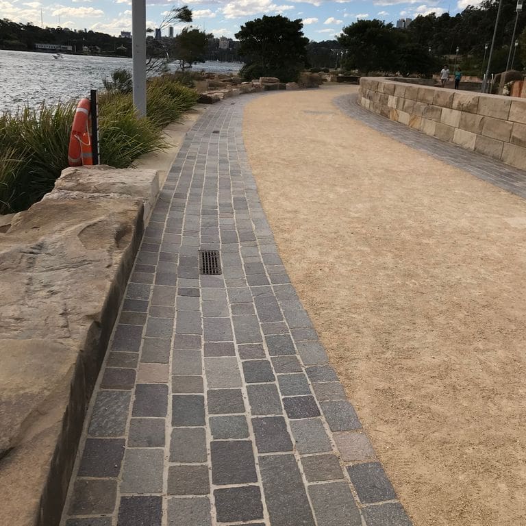 The image shows this material being used for driveway pavers and path pavers.